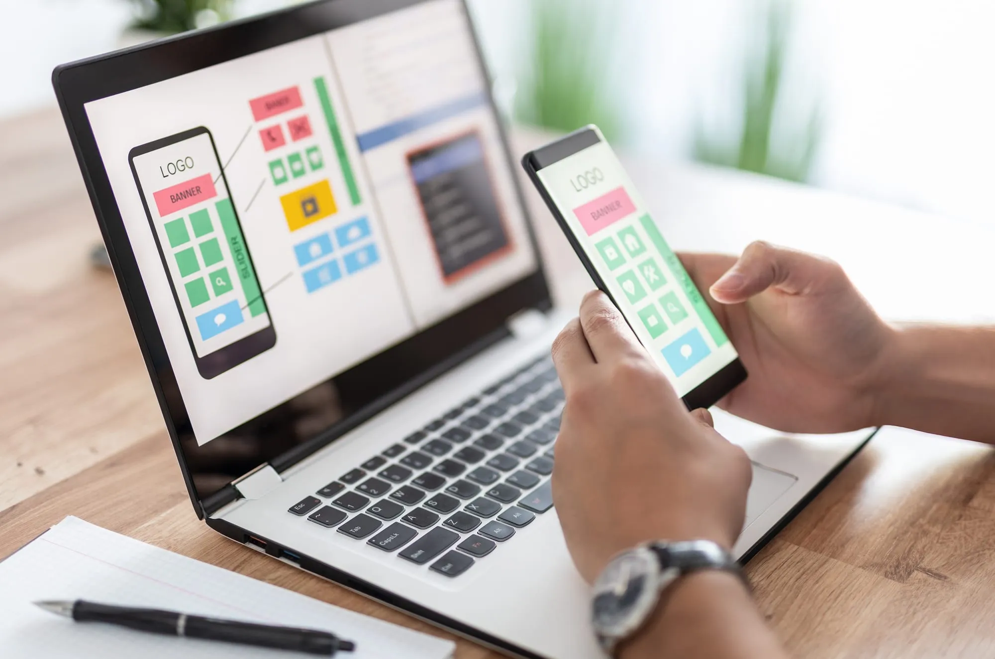 Designer building a website layout on a desktop computer